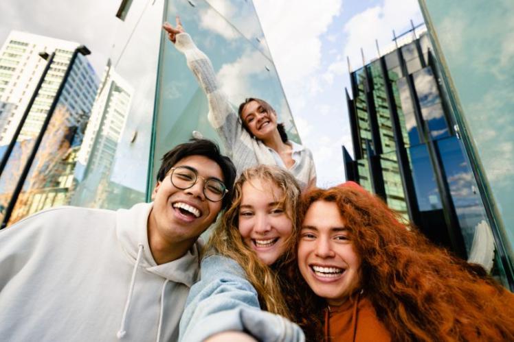 students posing for a photo in a city